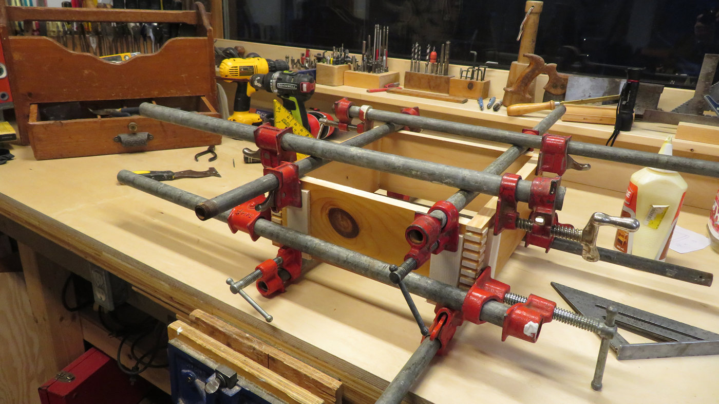 Cylinder head shipping box glued and clamped on workbench