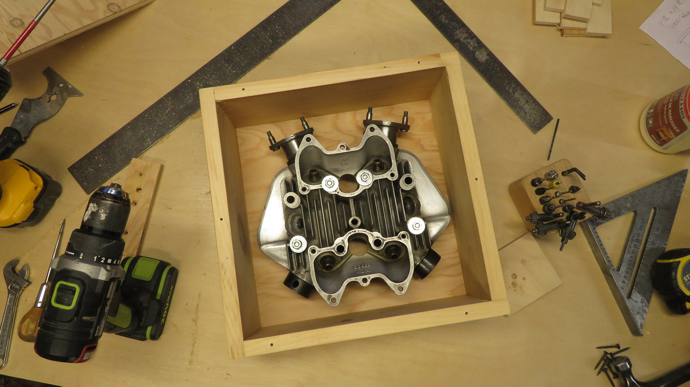 Motorcycle cylinder head bolted into shipping box