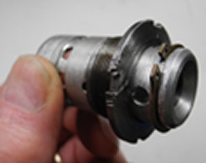 Photo illustration of pre-assembled shuttle valve, bearing nut, and circlip