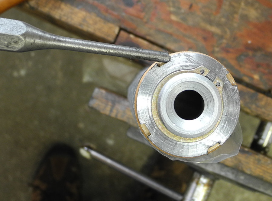 Photo illustrating tightening the bearing nut using a drift