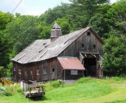 Photo of barn with roof caving in